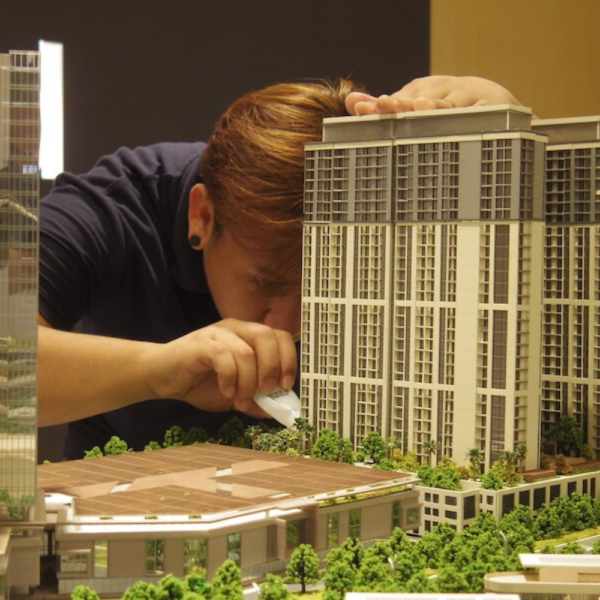 Man working on detailed 3D printed tower model