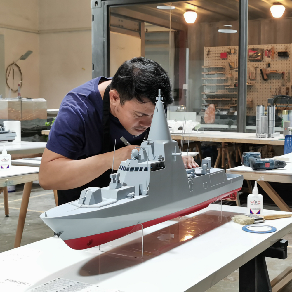 Man working on 3D printed boat model